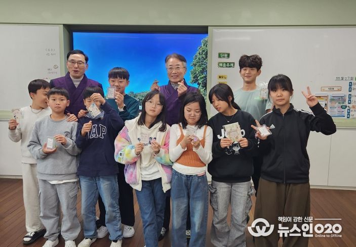 선비교사와 함께 단체 사진을 찍고 있는 어린이들