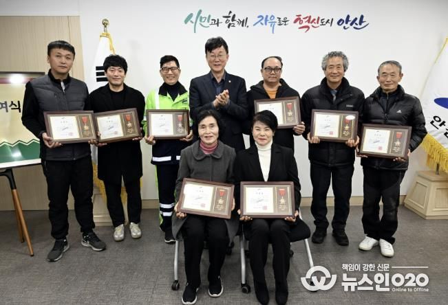 이민근 안산시장(뒷줄 가운데)이 모범시민으로 선정한 환경미화원 8명에게 표창장을 수여하고, 함께 기념촬영을 하고 있다.
